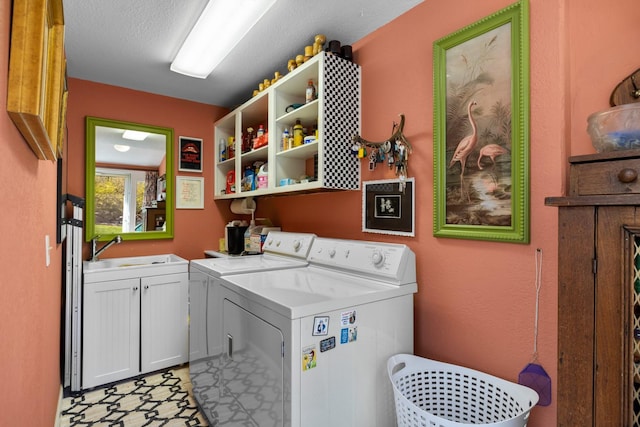 laundry room with independent washer and dryer, a sink, and cabinet space