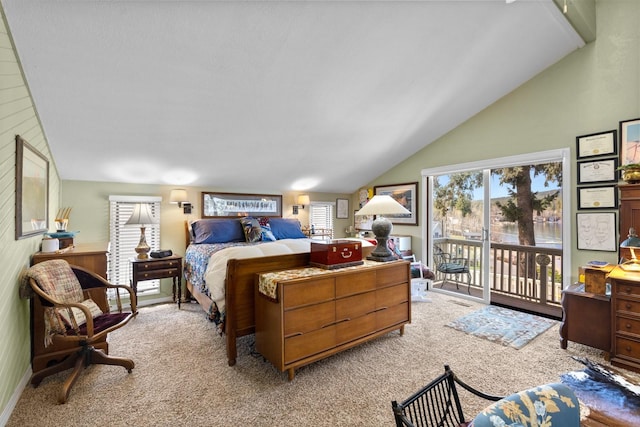 bedroom with access to outside, light colored carpet, and lofted ceiling