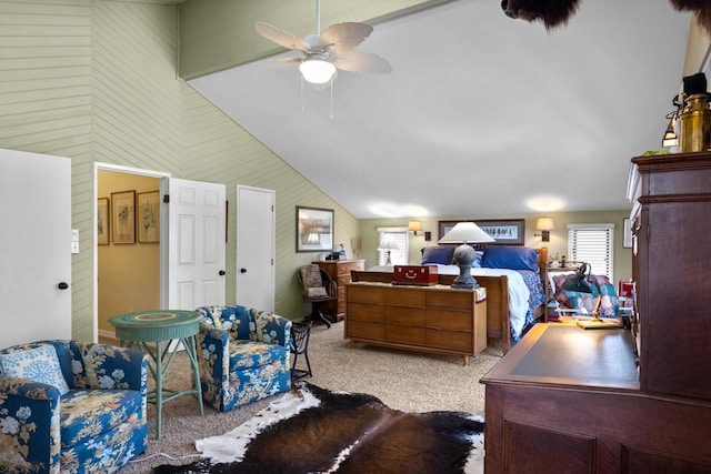 carpeted bedroom with ceiling fan and vaulted ceiling