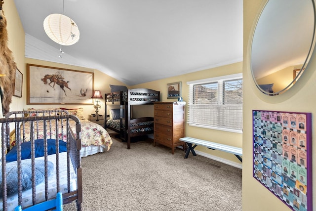 bedroom featuring baseboards, lofted ceiling, and carpet