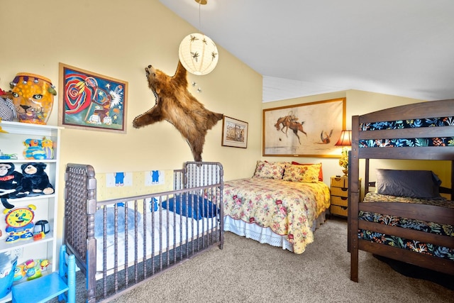 bedroom with carpet flooring and vaulted ceiling