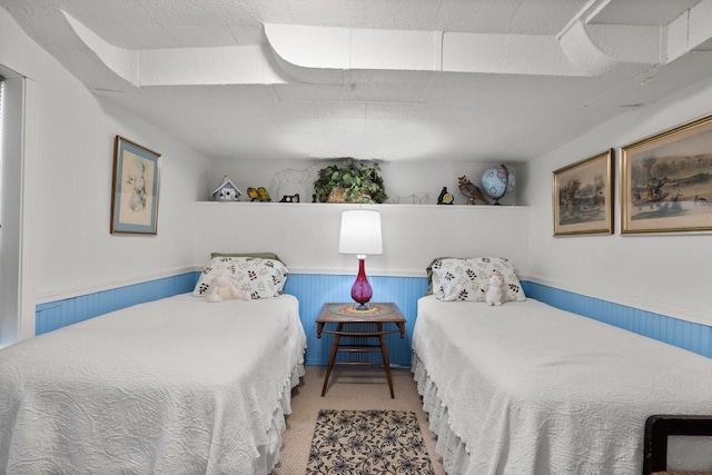 bedroom with carpet flooring and a wainscoted wall
