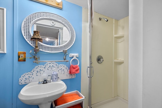 full bath with a sink and a stall shower