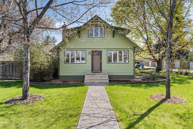 226 S Davis St, Missoula, MT 59801 - bungalow-style home with a front lawn, fence, a chimney, and entry steps