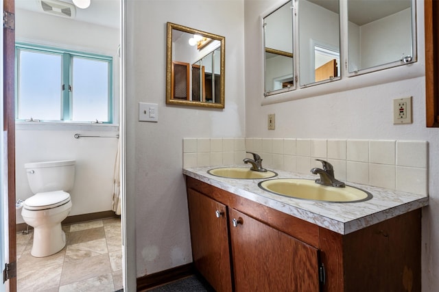 226 S Davis St, Missoula, MT 59801 - full bathroom with a sink, baseboards, toilet, and double vanity