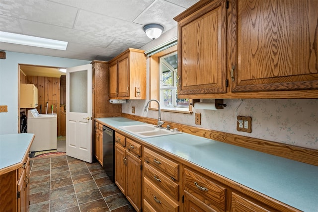 226 S Davis St, Missoula, MT 59801 - kitchen featuring washer / dryer, brown cabinetry, dishwasher, light countertops, and dark stone finish floors