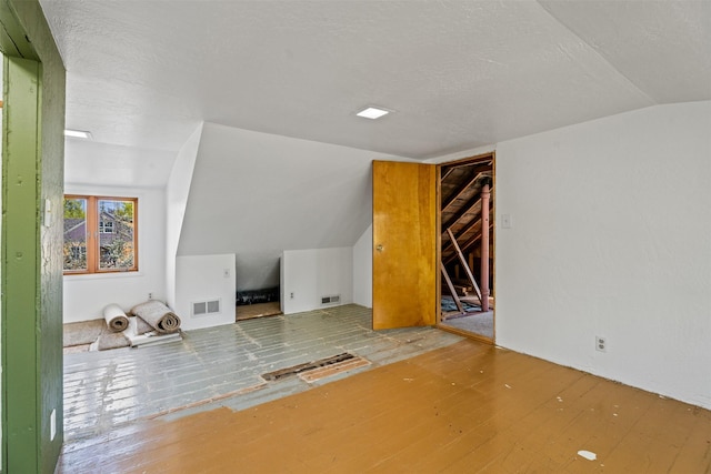 226 S Davis St, Missoula, MT 59801 - bonus room featuring vaulted ceiling, wood finished floors, and a textured ceiling