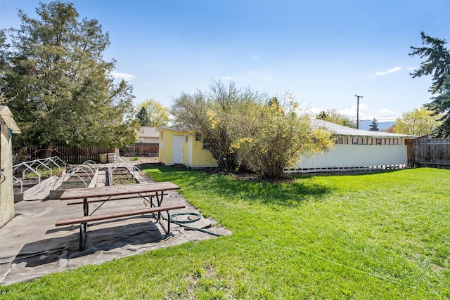 226 S Davis St, Missoula, MT 59801 - view of yard with an outdoor structure, a fenced backyard, a patio area, and a shed