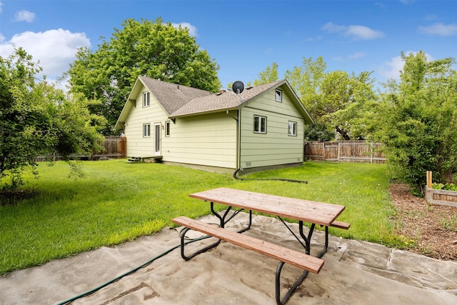 226 S Davis St, Missoula, MT 59801 - rear view of property featuring a fenced backyard, a patio area, and roof with shingles