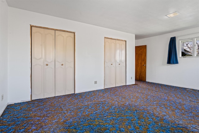 226 S Davis St, Missoula, MT 59801 - unfurnished bedroom featuring multiple closets and carpet flooring