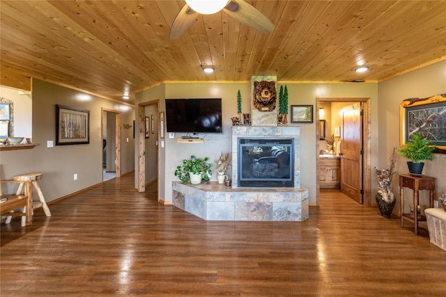 living area with wood finished floors, baseboards, ceiling fan, wood ceiling, and a tile fireplace