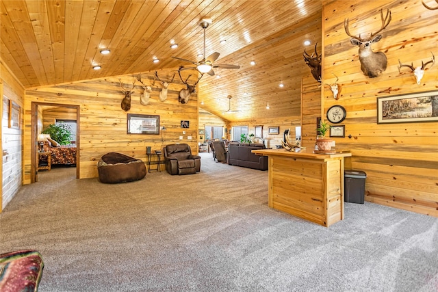 office area with wooden walls, light carpet, and lofted ceiling