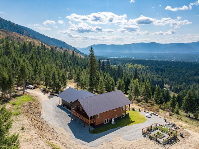 birds eye view of property featuring a mountain view and a forest view