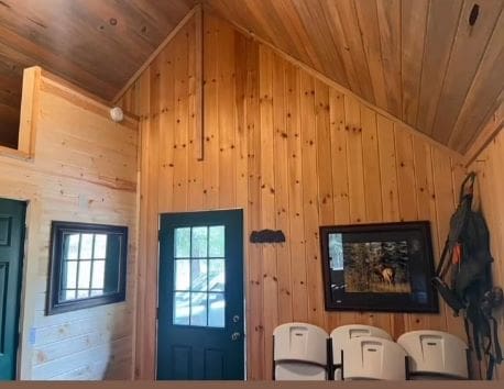 entryway with wooden walls, wooden ceiling, and vaulted ceiling
