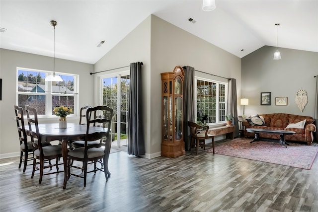 dining space featuring high vaulted ceiling, baseboards, wood finished floors, and visible vents