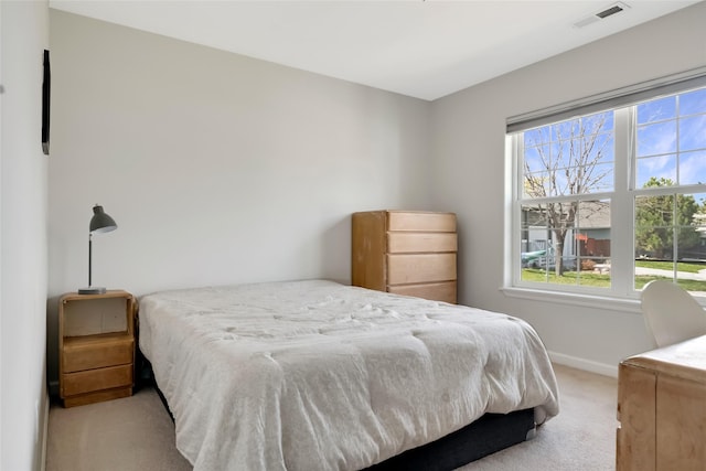 carpeted bedroom with baseboards and visible vents