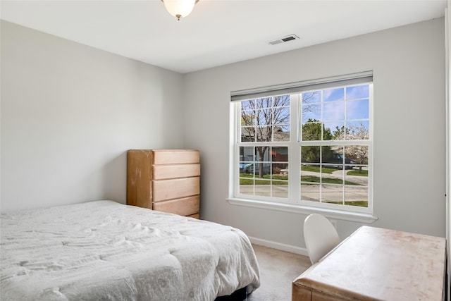 bedroom with baseboards, carpet, and visible vents