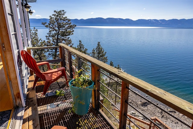 balcony featuring a water and mountain view