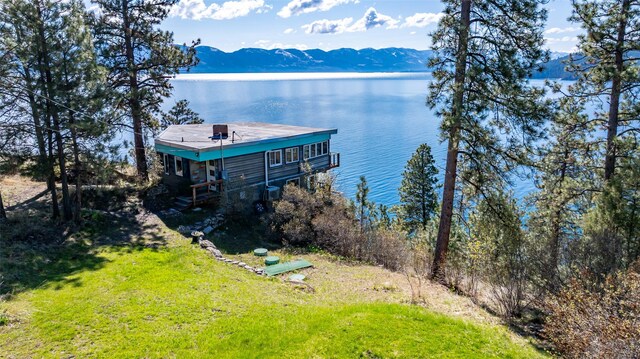 exterior space with a water and mountain view