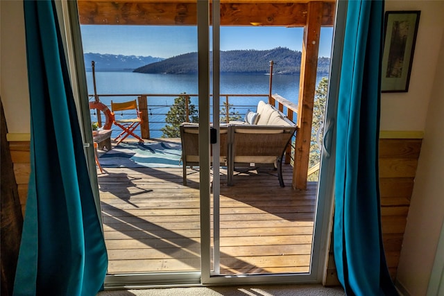 deck with a water and mountain view