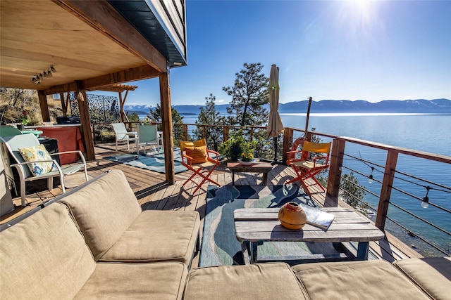 view of patio / terrace with a water and mountain view