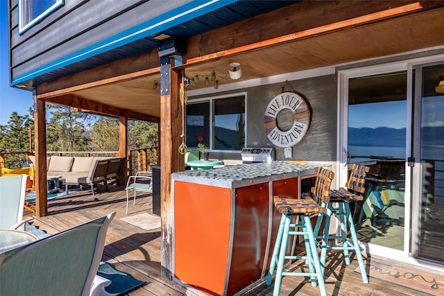 wooden deck with an outdoor living space and outdoor dry bar