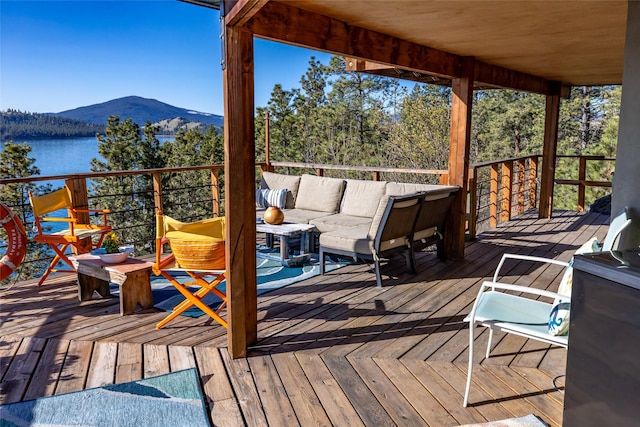 wooden deck with outdoor lounge area and a mountain view