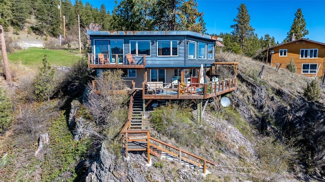 back of house with a deck