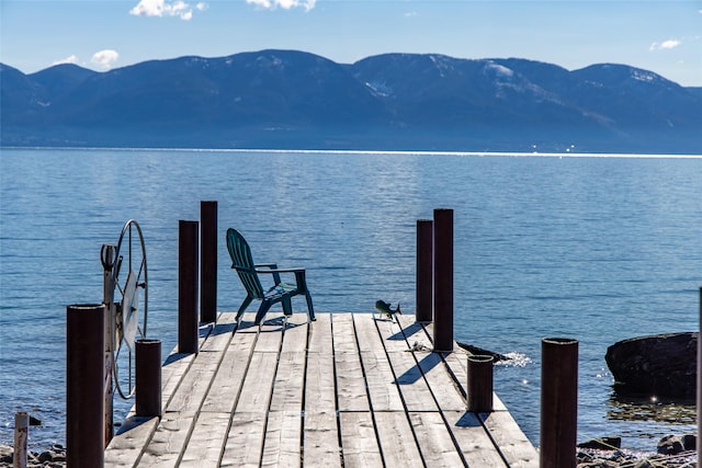 view of dock with a water and mountain view