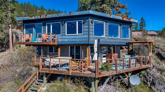 rear view of house featuring a wooden deck