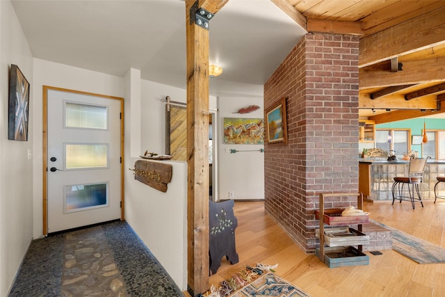 interior space with wood finished floors and beamed ceiling