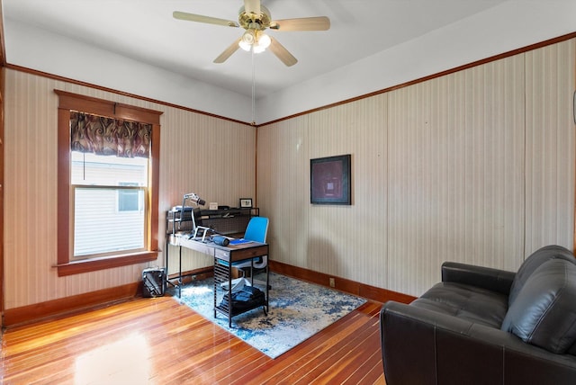 office space featuring baseboards, a ceiling fan, and wood finished floors