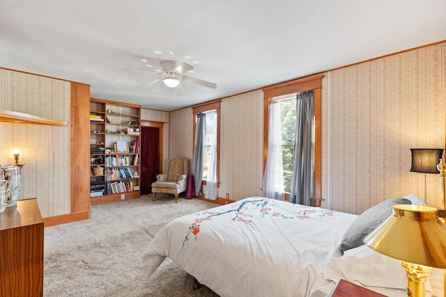 bedroom featuring carpet floors, ceiling fan, wallpapered walls, and baseboards