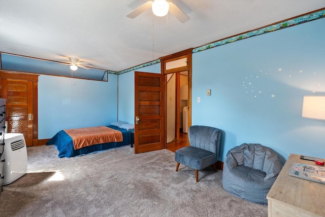 carpeted bedroom featuring a ceiling fan and washer / dryer