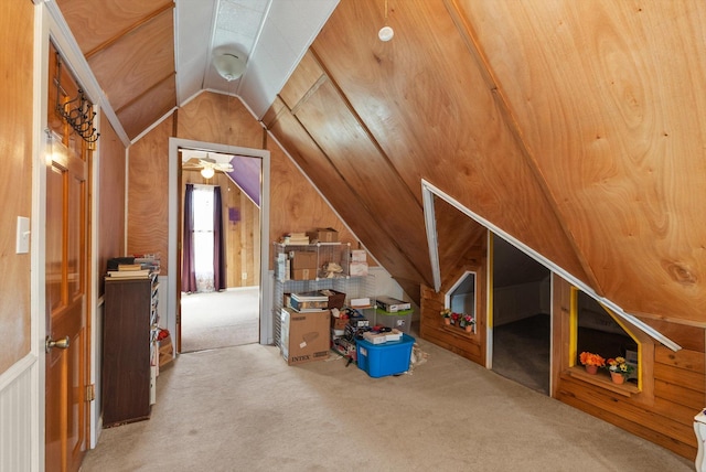 bonus room with carpet flooring, wooden walls, and lofted ceiling