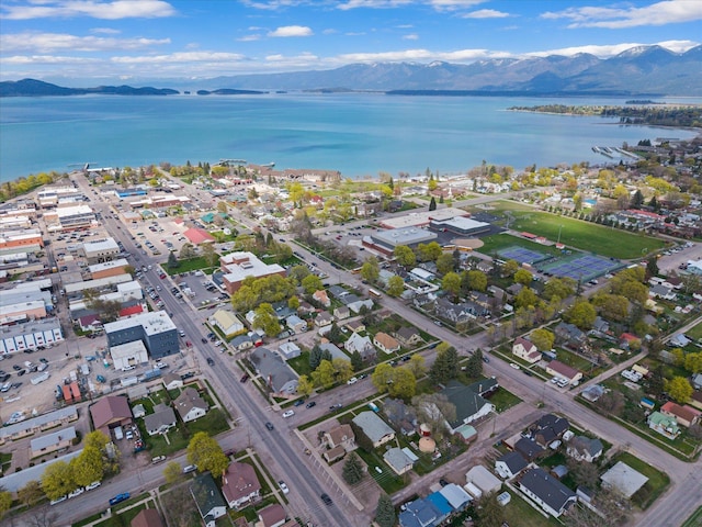birds eye view of property with a water and mountain view