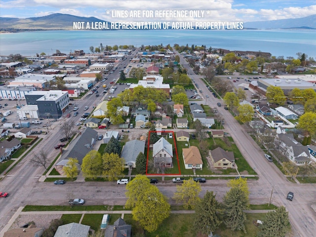 birds eye view of property featuring a water and mountain view