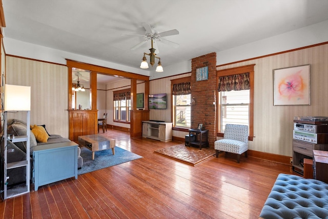 living room with plenty of natural light, a ceiling fan, baseboards, and hardwood / wood-style floors