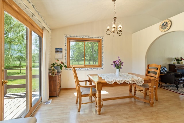 19720 Leo Hansen Rd, Florence, MT 59833 - dining room featuring a notable chandelier, visible vents, baseboards, light wood-type flooring, and vaulted ceiling