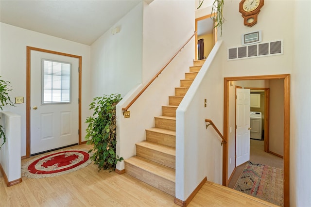 19720 Leo Hansen Rd, Florence, MT 59833 - entrance foyer with visible vents, stairs, washer / dryer, and wood finished floors
