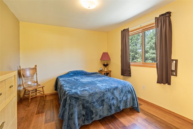 19720 Leo Hansen Rd, Florence, MT 59833 - bedroom featuring baseboards and wood finished floors