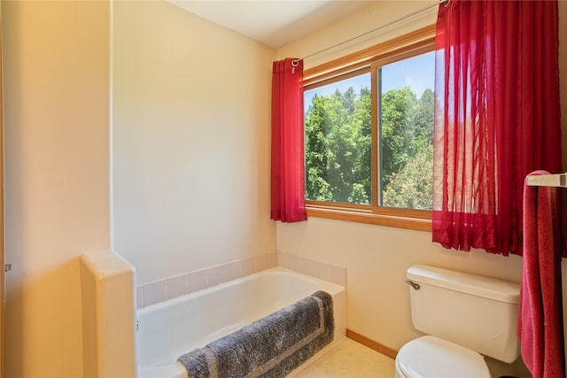 19720 Leo Hansen Rd, Florence, MT 59833 - full bathroom with toilet, baseboards, and a garden tub