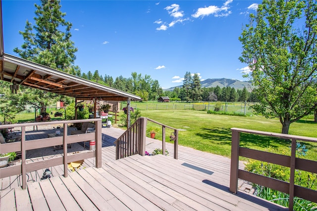 19720 Leo Hansen Rd, Florence, MT 59833 - wooden deck with a lawn, a rural view, a mountain view, and a fenced backyard