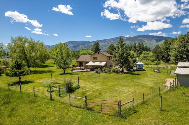 19720 Leo Hansen Rd, Florence, MT 59833 - surrounding community with fence, a mountain view, a lawn, and a rural view