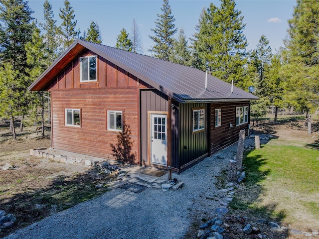 exterior space featuring board and batten siding and metal roof