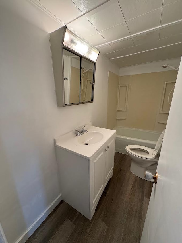 full bathroom with toilet, shower / bath combination, wood finished floors, and vanity