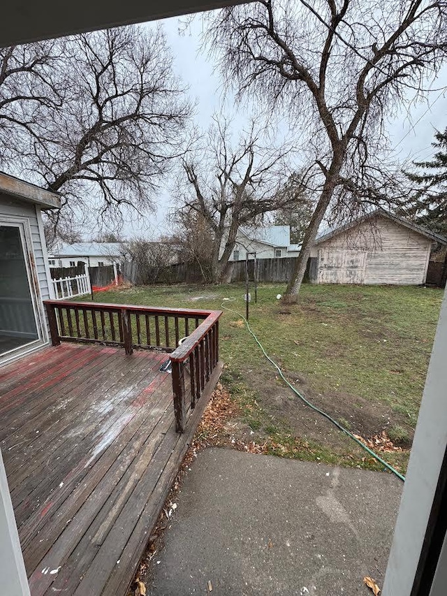 deck featuring a fenced backyard and a yard