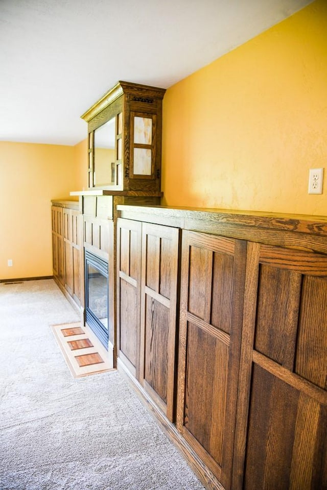 interior details featuring carpet floors and a fireplace with flush hearth