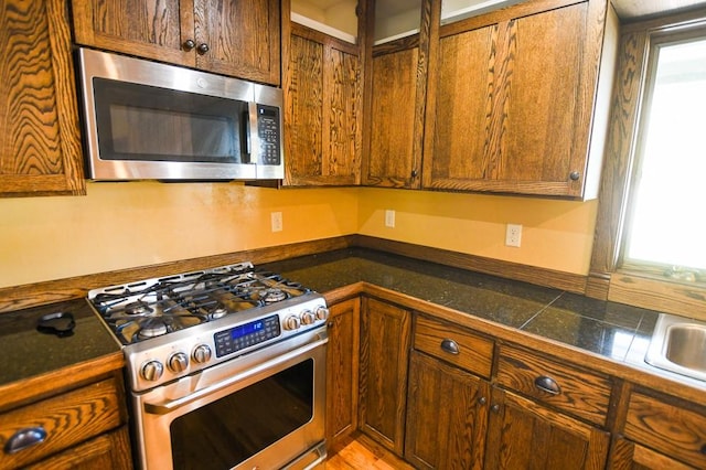 kitchen with glass insert cabinets and stainless steel appliances