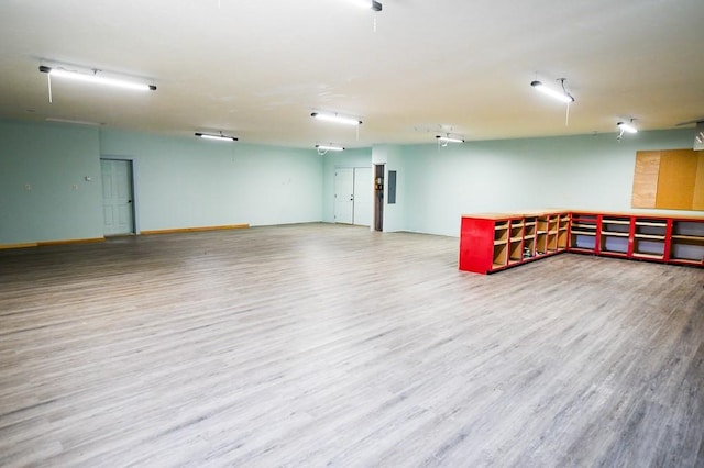 below grade area with wood finished floors and a workshop area